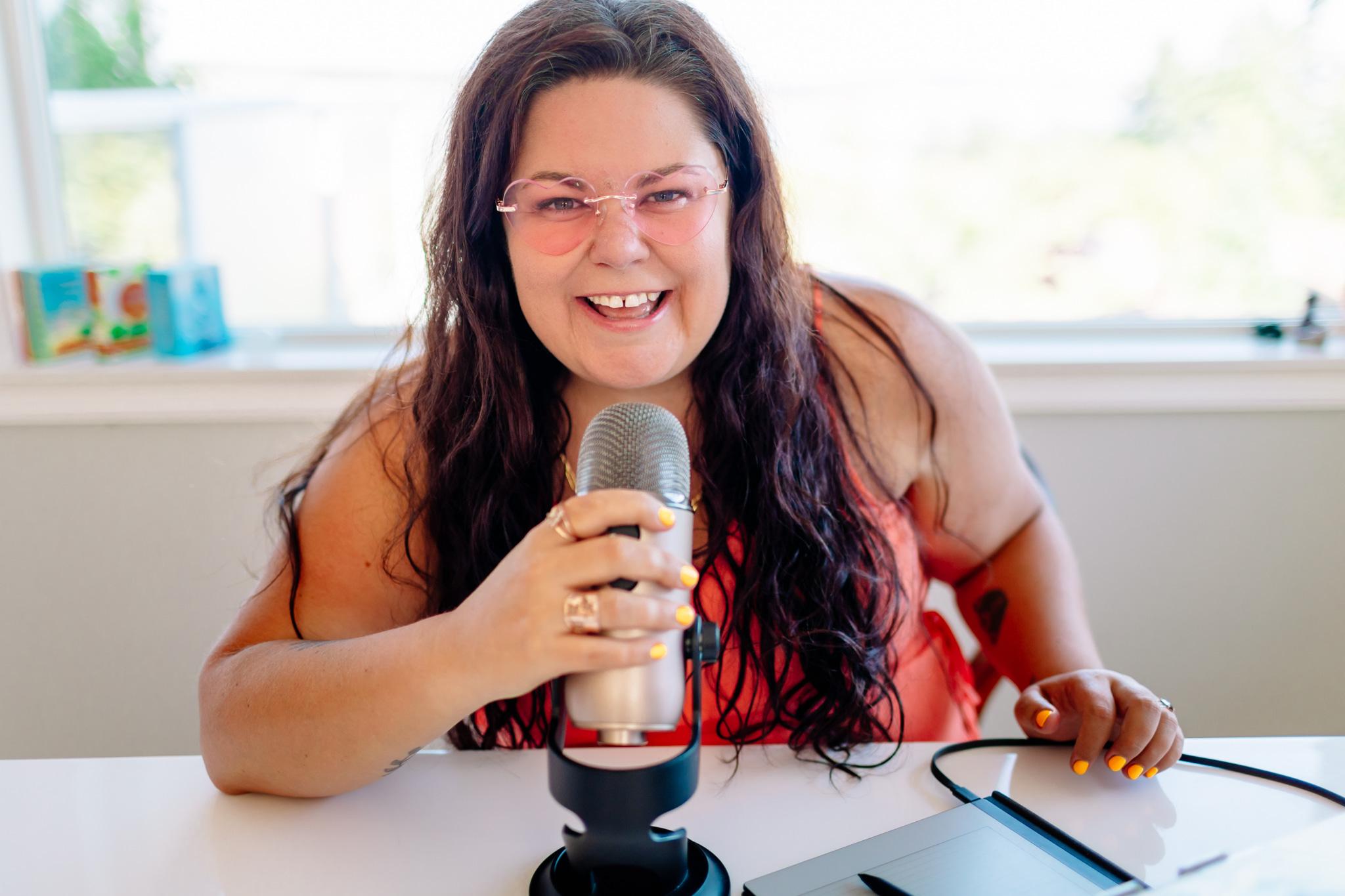 Crystal Adair-Benning recording a podcast at a microphone