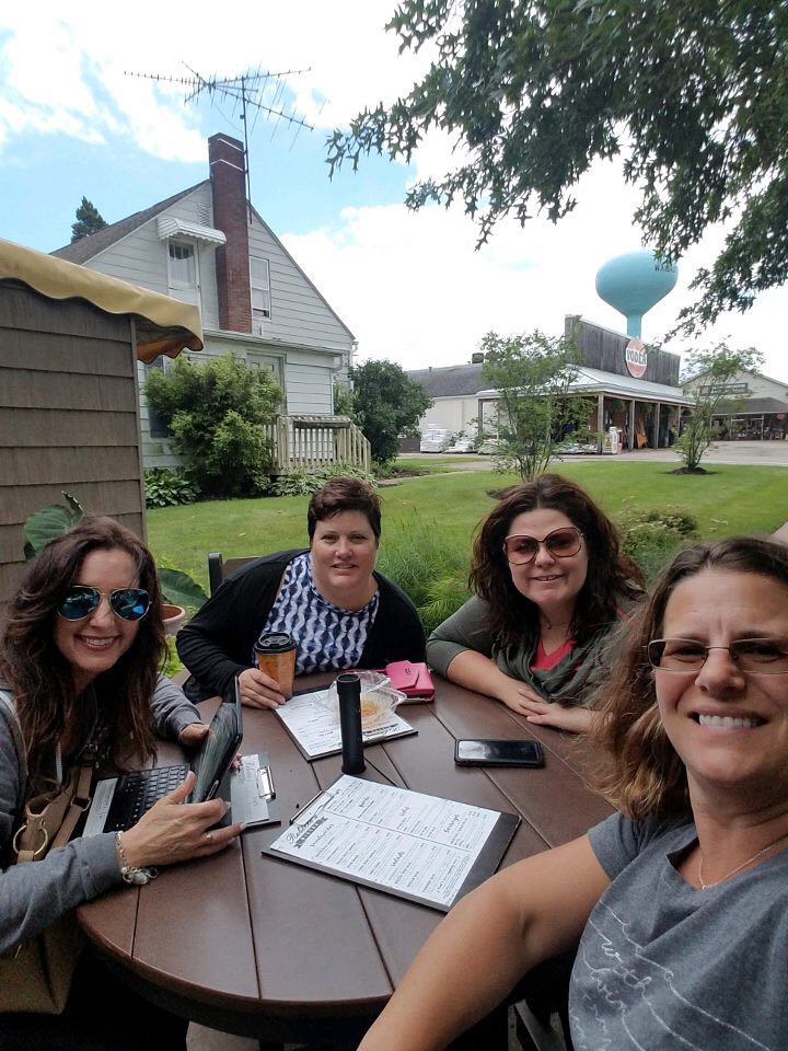 Crystal Adair-Benning with clients at an outdoor lunch gathering