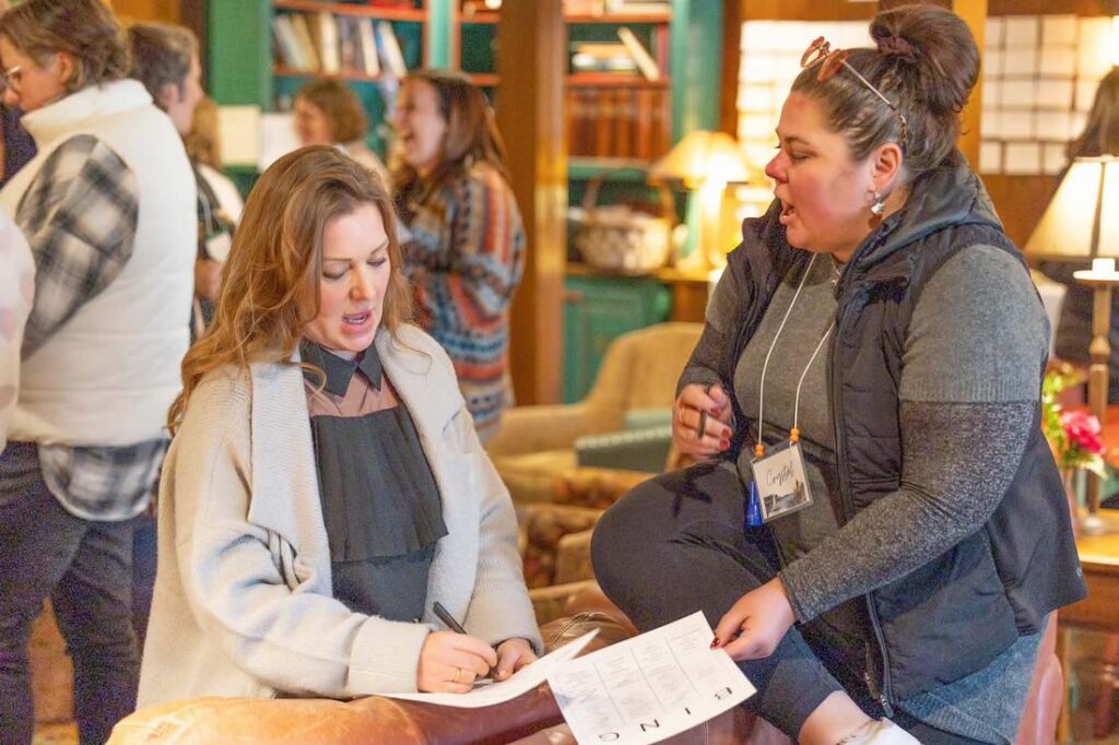 Crystal Adair-Benning coaching a client at a table