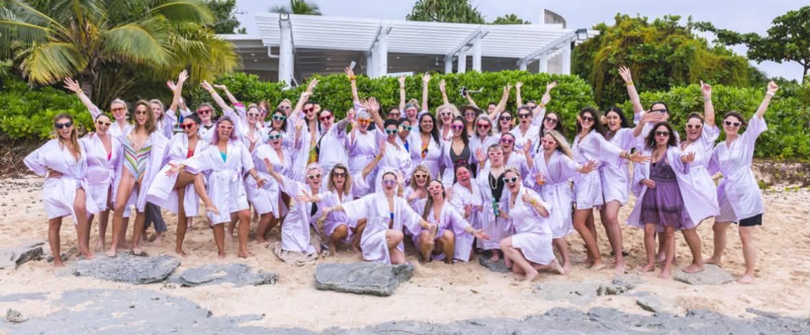 Crystal Adair-Benning with the full SheEvolves group on the beach in Fiji
