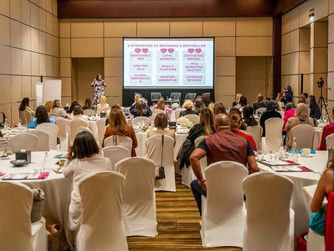 Crystal Adair-Benning delivering the bestseller keynote to a full room at Speak Up Light Up in Dubai