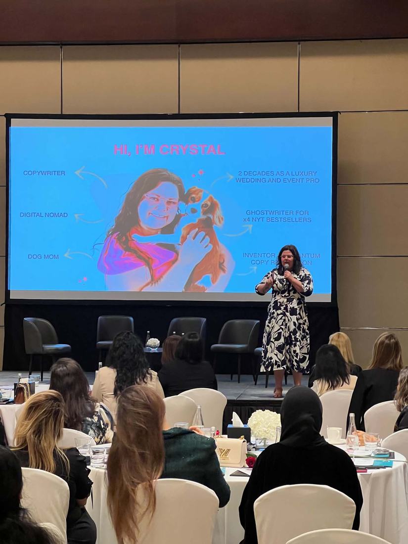 Crystal Adair-Benning on stage with a microphone at Speak Up Light Up, Dubai