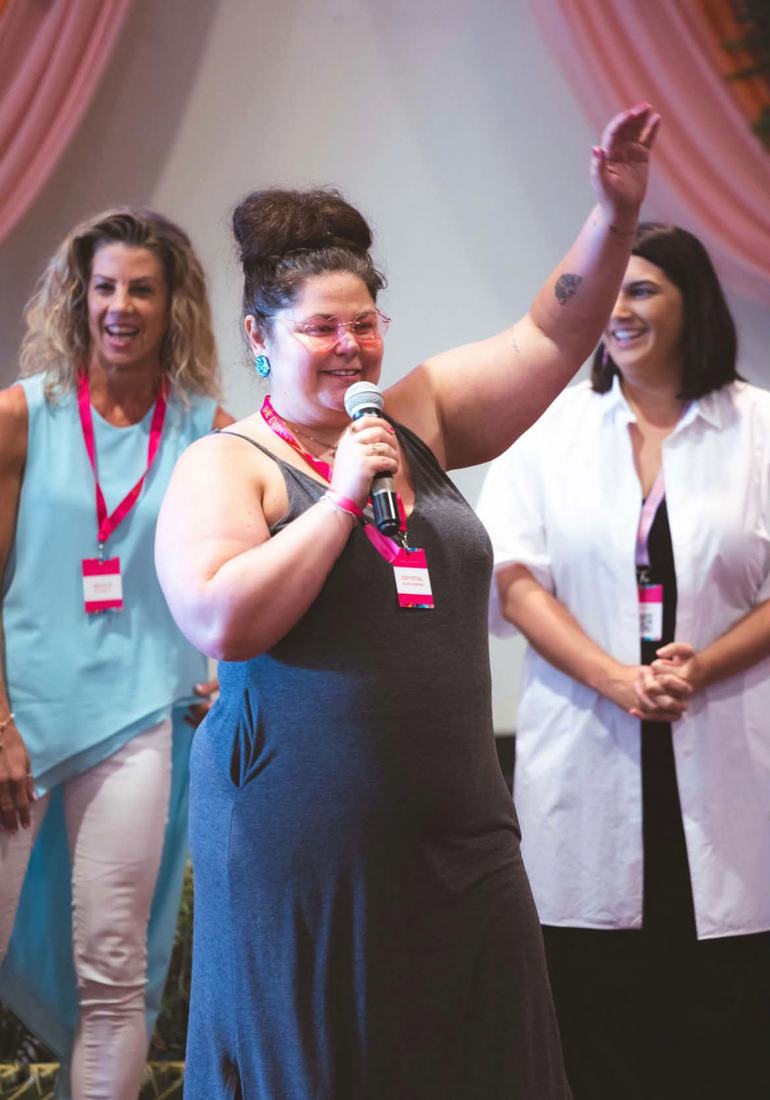 Crystal Adair-Benning closing the room with the microphone at SheEvolves in Fiji