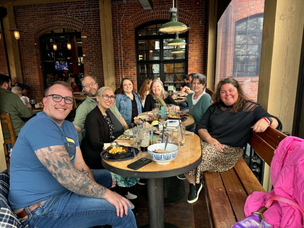 A group of writers gathered around a table at a retreat
