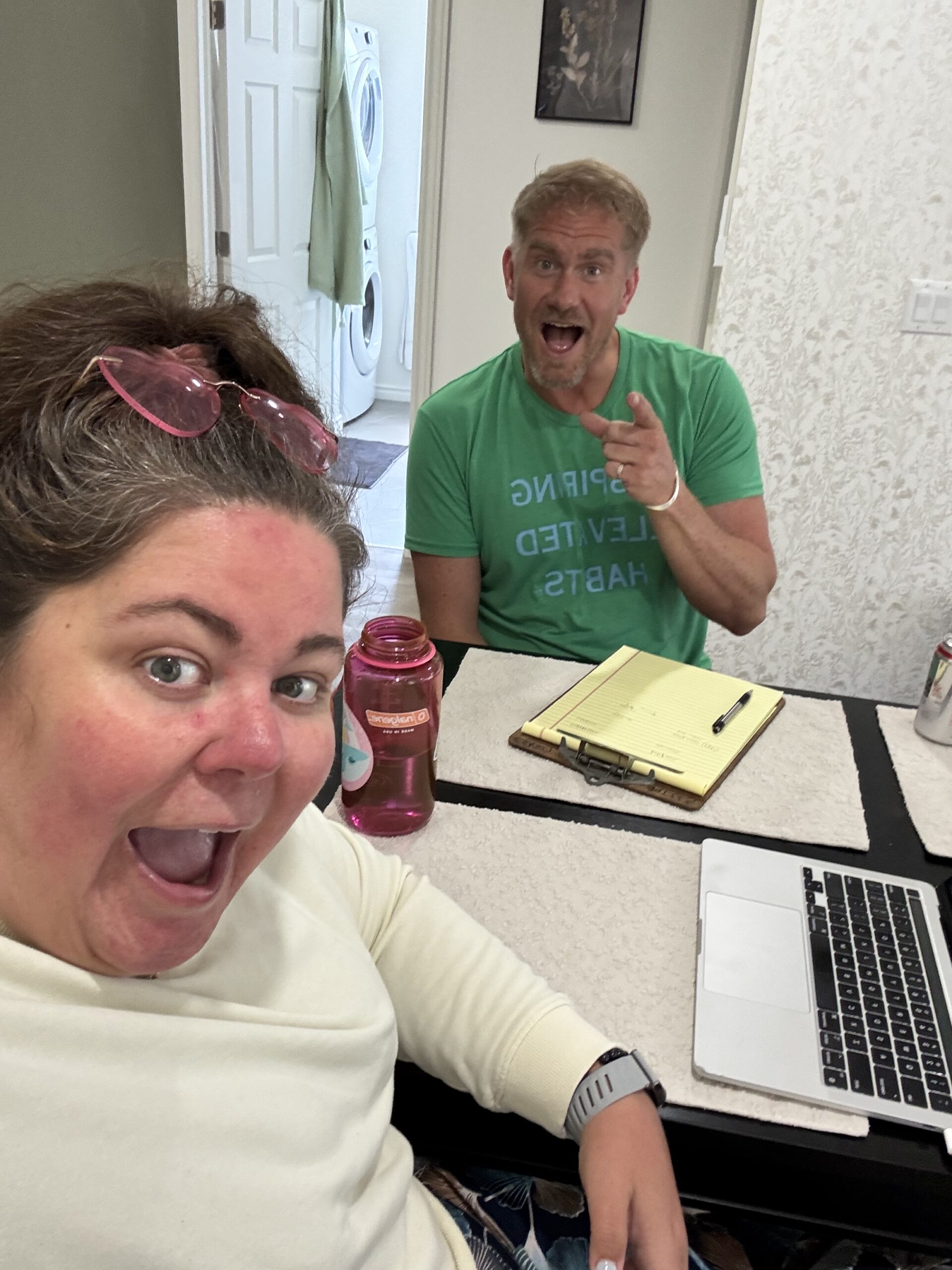 Crystal Adair-Benning co-writing with a client, manuscript on screen