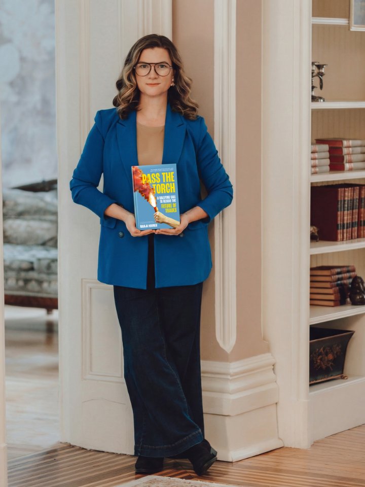 Manja Horner holding her book Pass the Torch