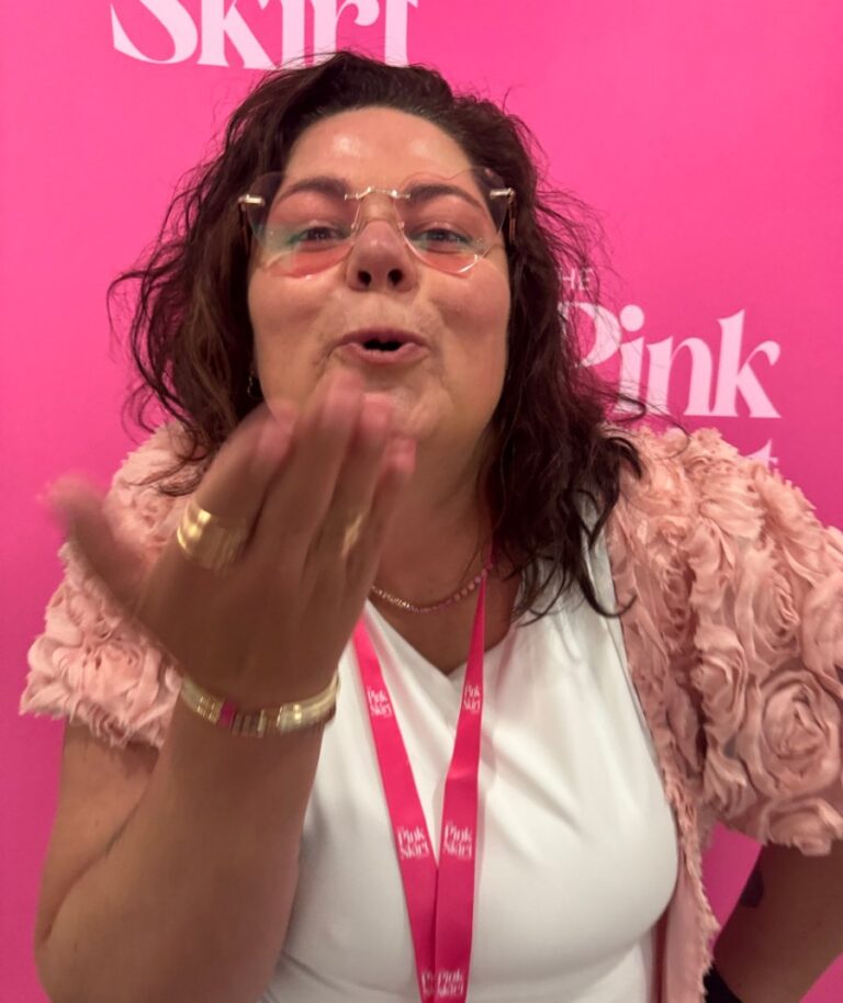 Crystal Adair-Benning blowing a kiss in pink heart glasses