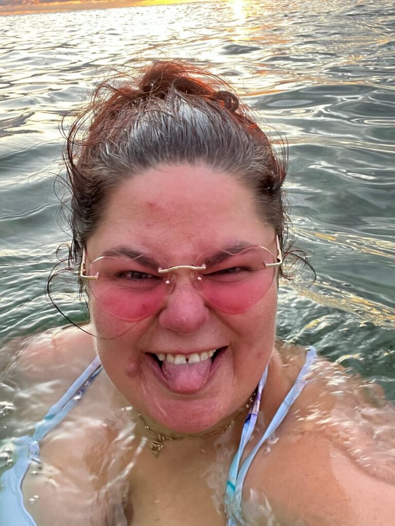 Crystal Adair-Benning in the ocean sticking her tongue out