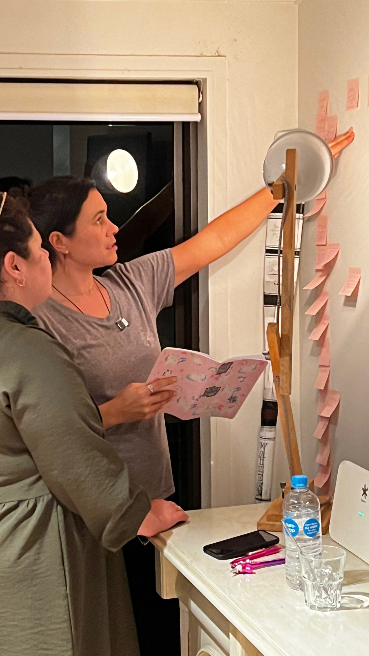 A writer putting chapter notes on sticky notes up a wall