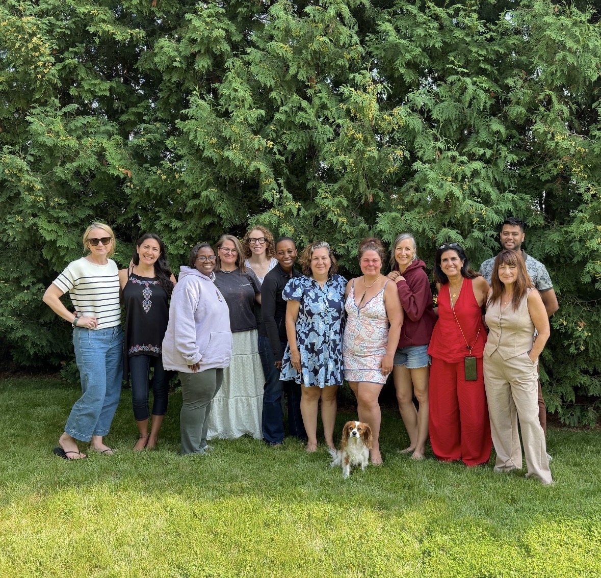 Crystal Adair-Benning with a group of writers and a dog on the lawn at a Createcation in Niagara-on-the-Lake, Ontario