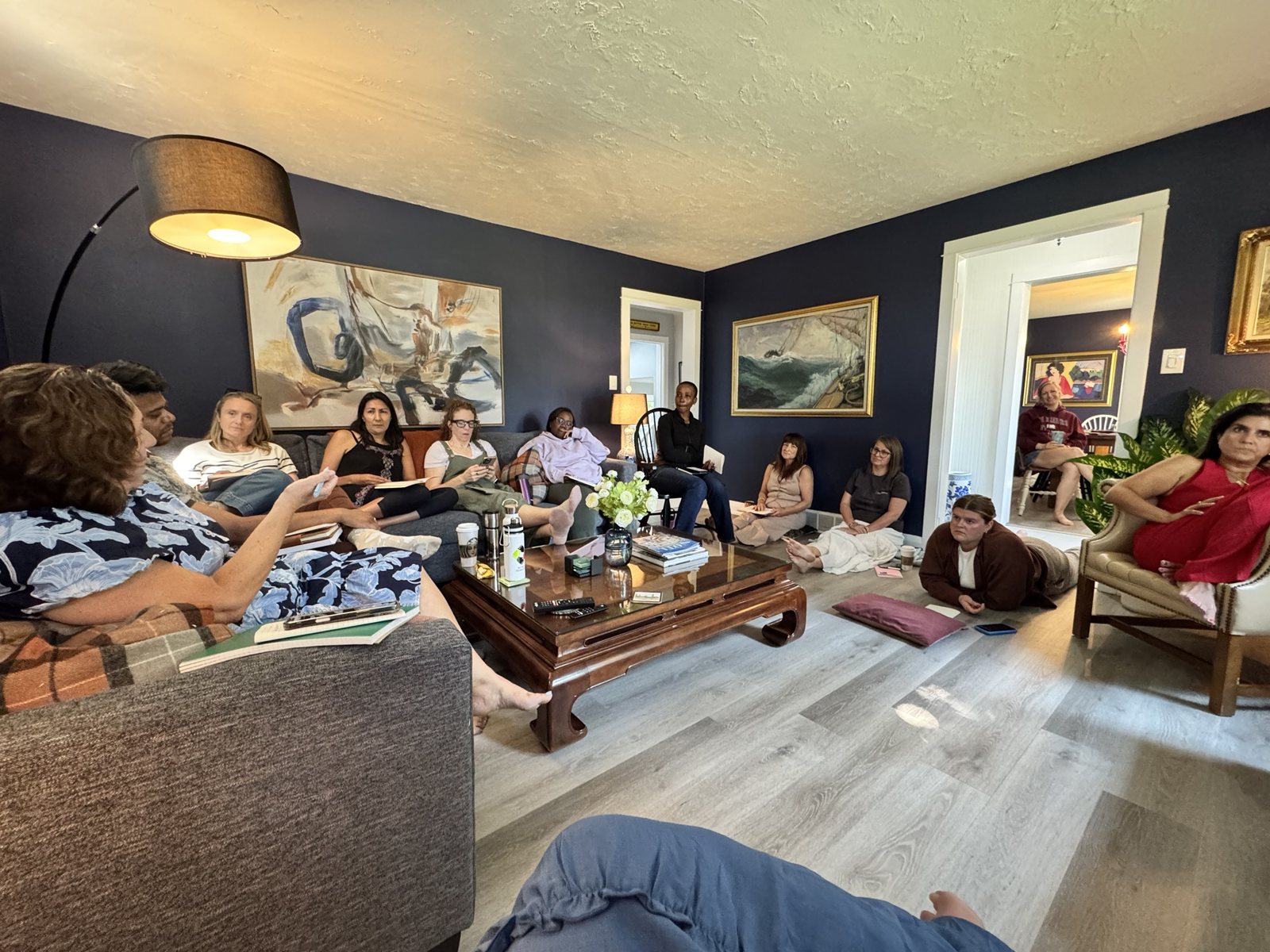 Writers gathered in a living room for a teaching session at a Createcation in Niagara-on-the-Lake