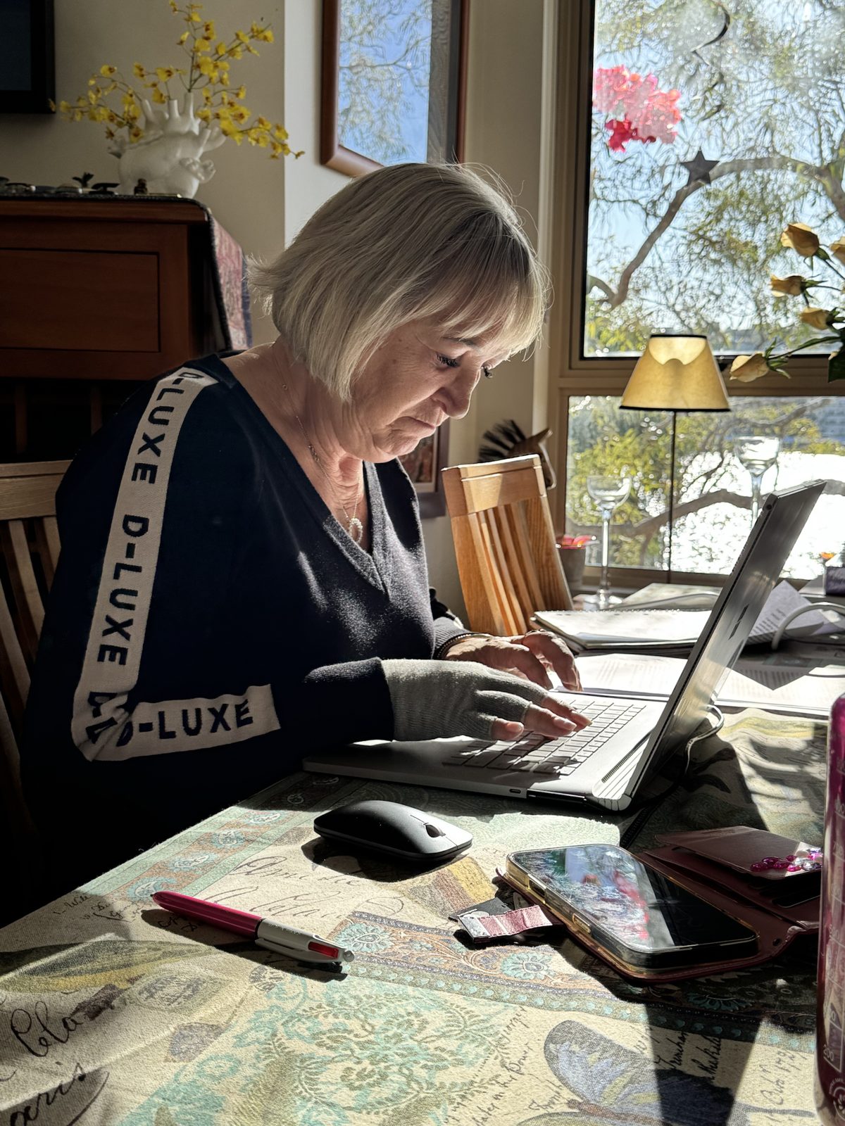 A writer working on her laptop at a sunny window in Sydney
