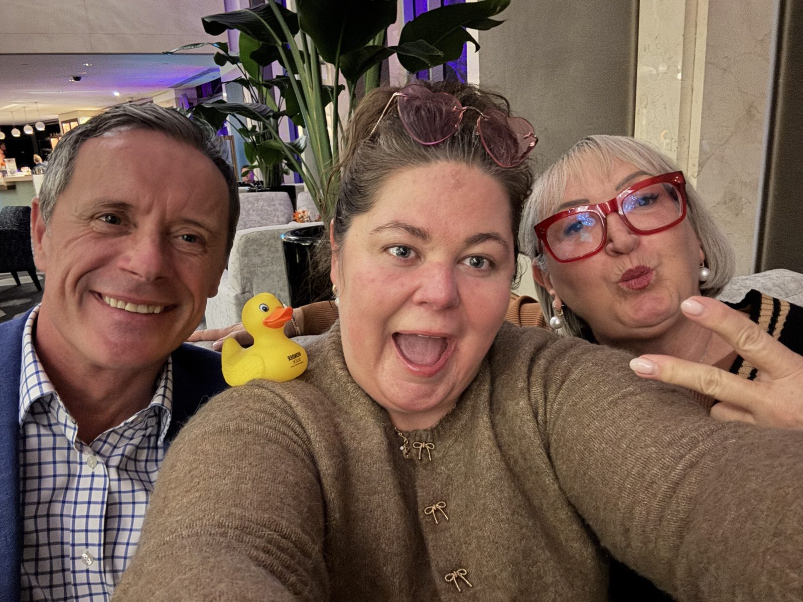 Crystal Adair-Benning taking a selfie with 2 friends and a yellow Wonder Duck in Sydney