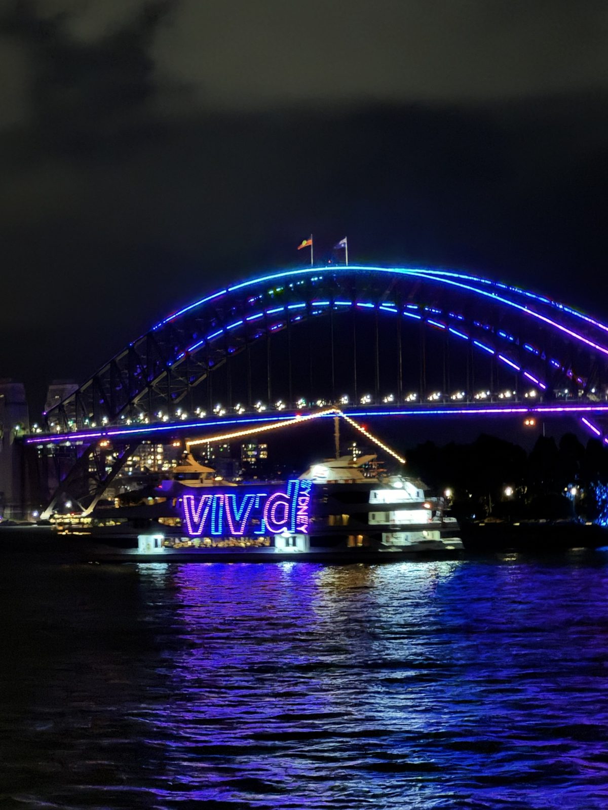 Sydney Harbour Bridge lit up in blue and purple during Vivid Sydney