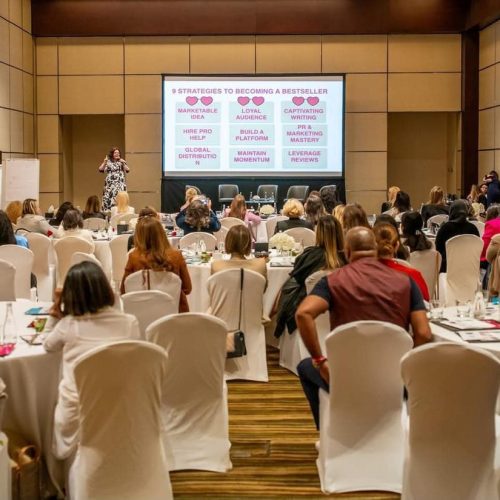 A conference ballroom filled with round tables of delegates