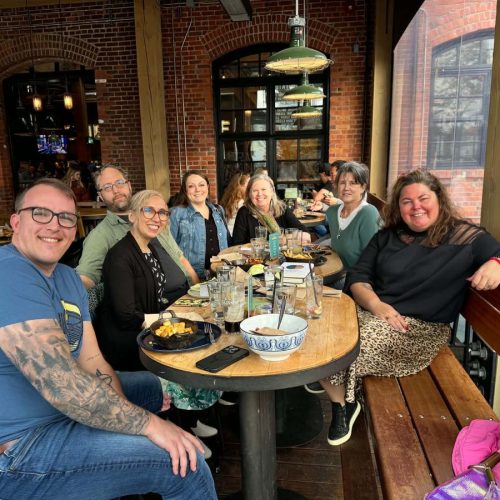 A group of writers gathered around a table at a retreat